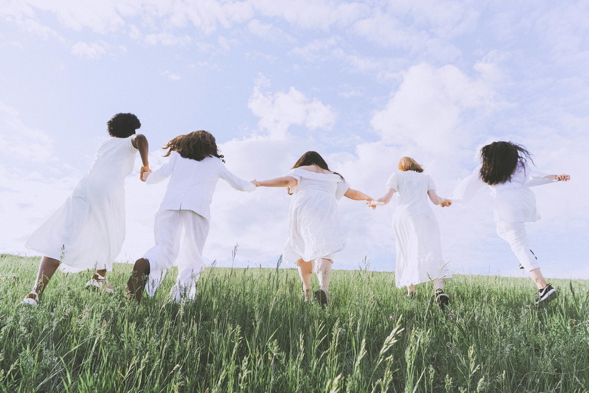 Women Running in Meadow